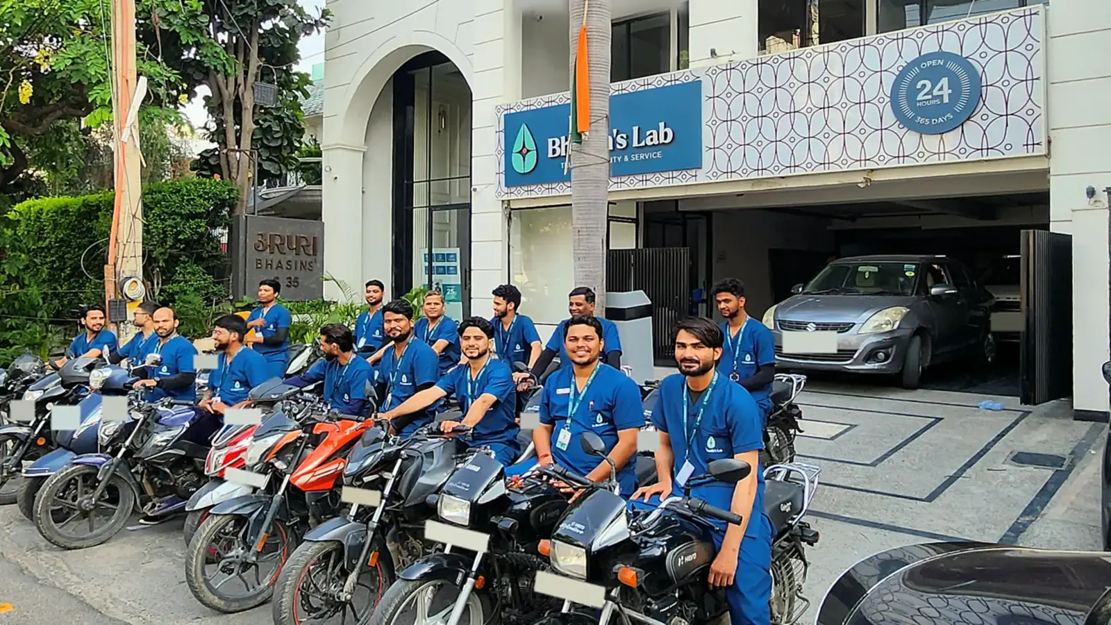 Dr Bhasin's Lab home collection team in blue uniforms on motorbikes outside the lab in Greater Kailash-I